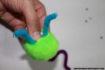 Press the arced pipe cleaner into the craft ball & bend the edges of the pipe cleaners.
