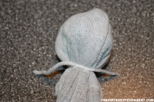 Use a strand of yarn or a rubber band & tie off under the ball to form the head shape.