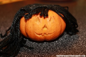 For mommy pumpkin, I just hot glued some yarn to the top of the pumpkin. I did the same for the baby & then braid the hair into pigtails