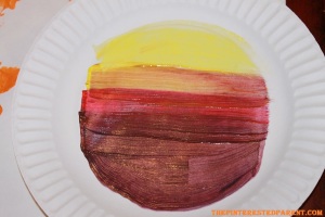 Paint another paper plate on the top side. Layer colors light to dark.