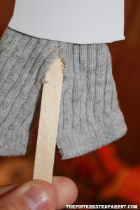 Cut the bottom portion of his sock up the center to give the appearance of pants.
