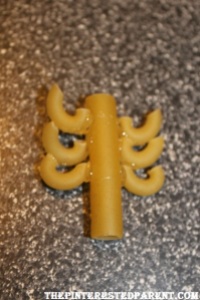 Glue 3 pieces of elbow macaroni to both ends of a piece of ziti as shown.